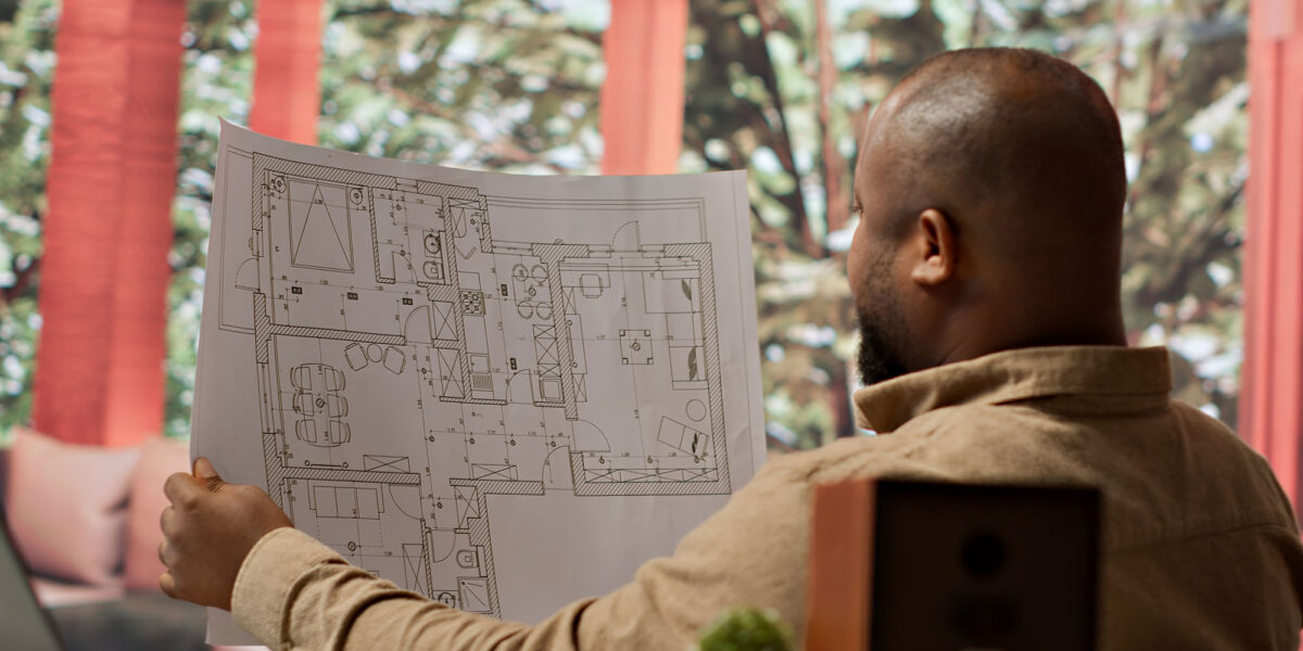 Man reviewing architectural plans in modern office