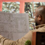Man reviewing architectural plans in modern office