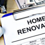 Clipboard with home renovation budget, calculator, and cash