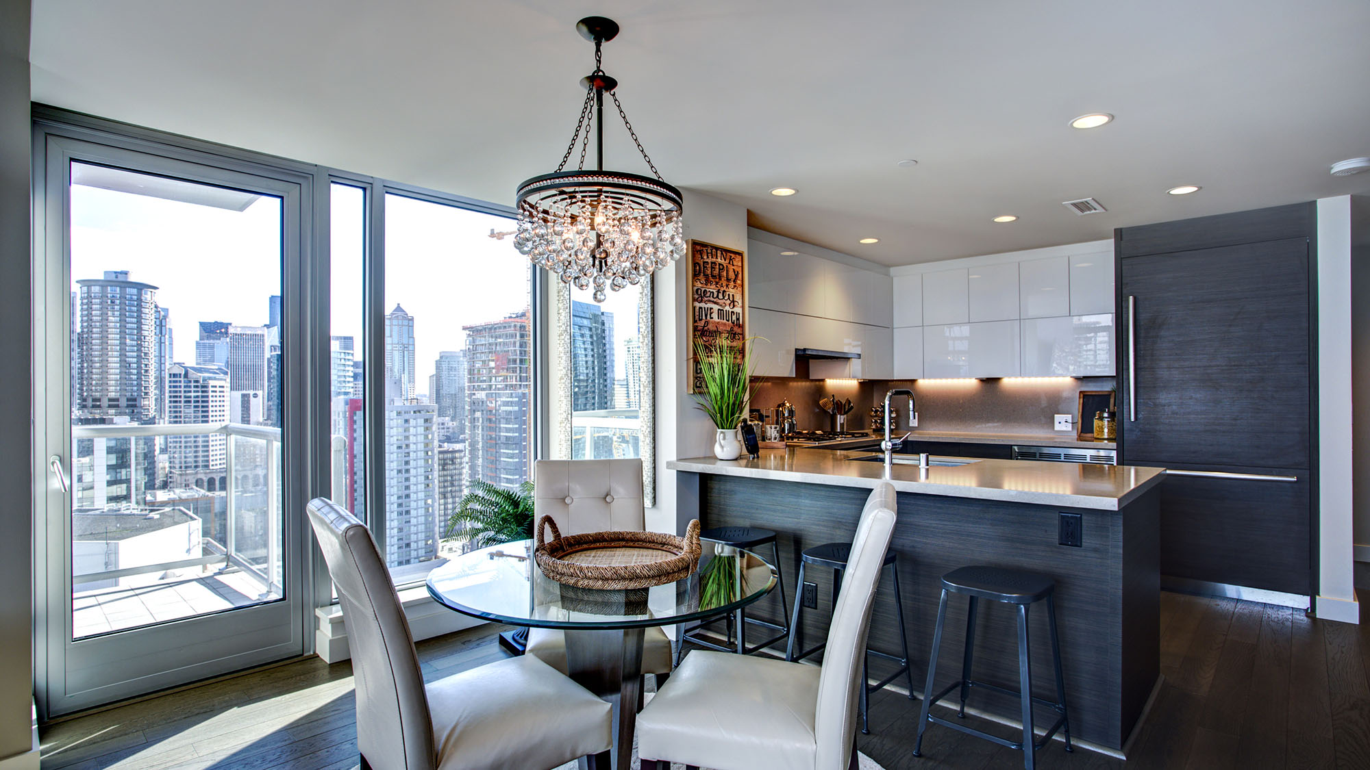 Modern condo kitchen with city skyline view