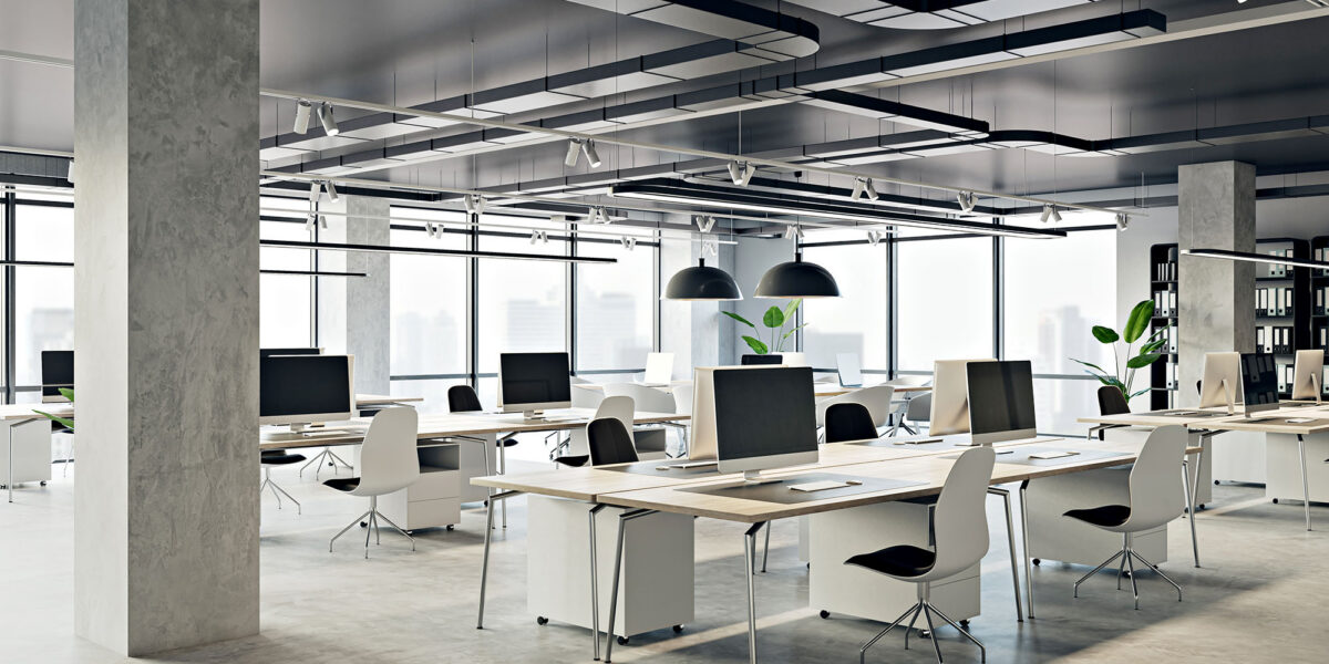 Modern open-plan office with sleek workstations and large windows