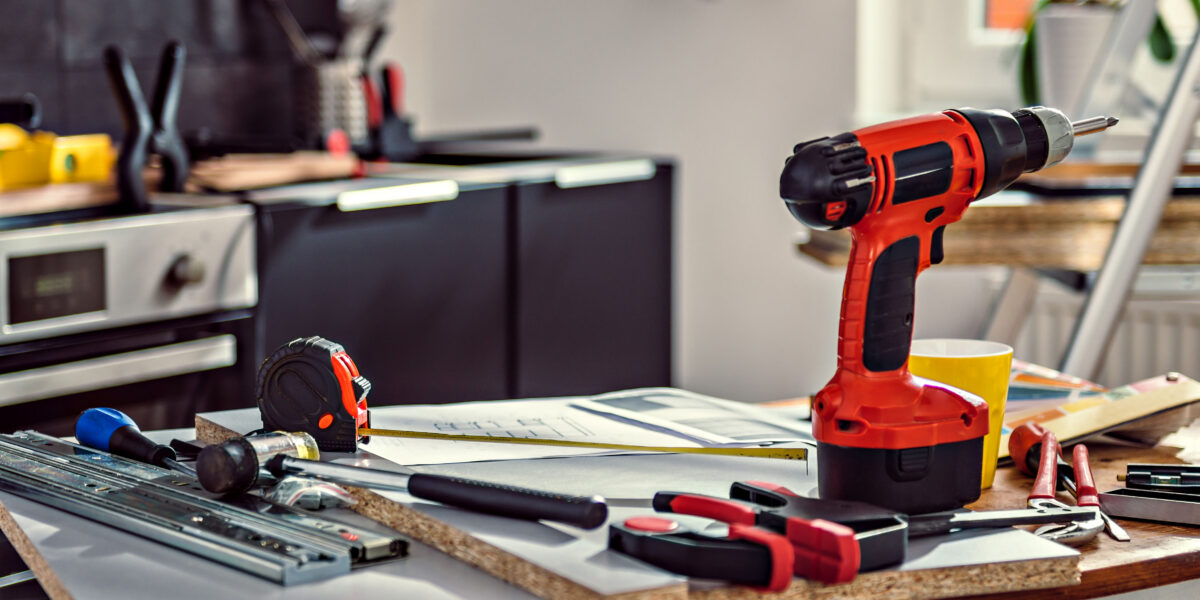 Red cordless drill and tools on kitchen renovation site