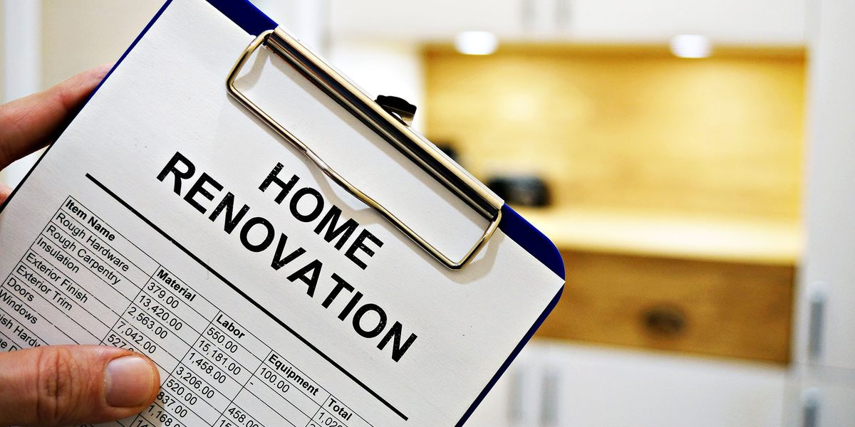 Home renovation checklist on clipboard in modern kitchen