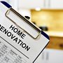 Home renovation checklist on clipboard in modern kitchen