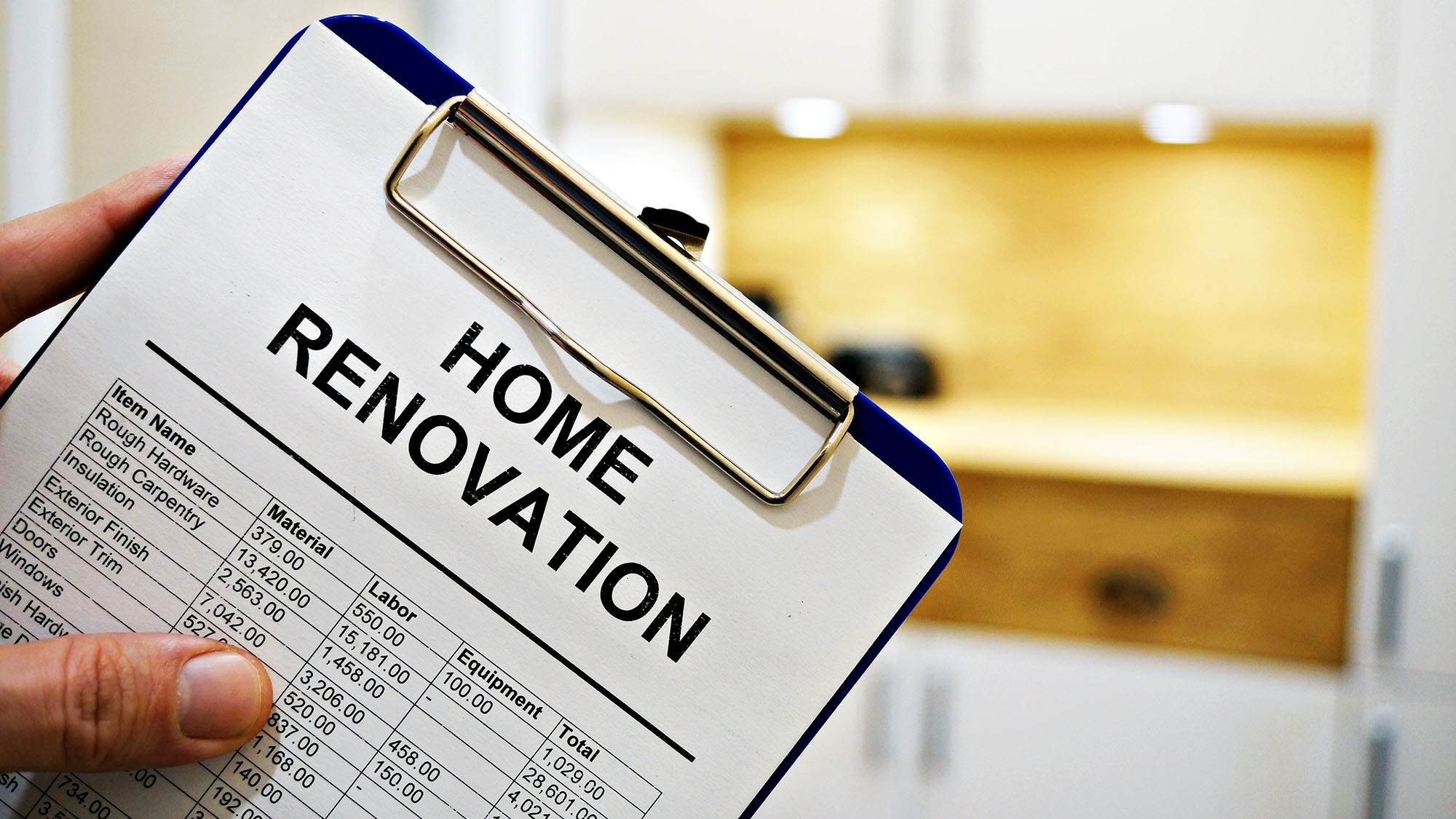 Home renovation checklist on clipboard in modern kitchen