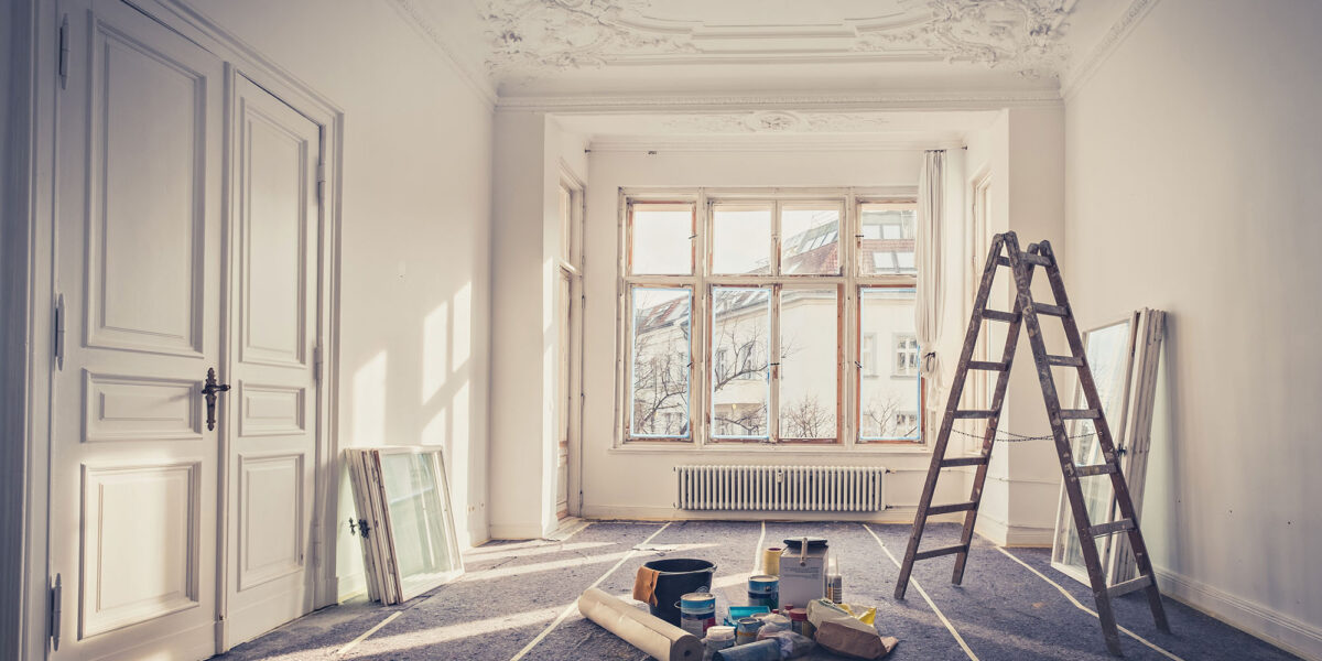 Elegant interior room under renovation with ladder and painting supplies