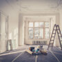 Elegant interior room under renovation with ladder and painting supplies