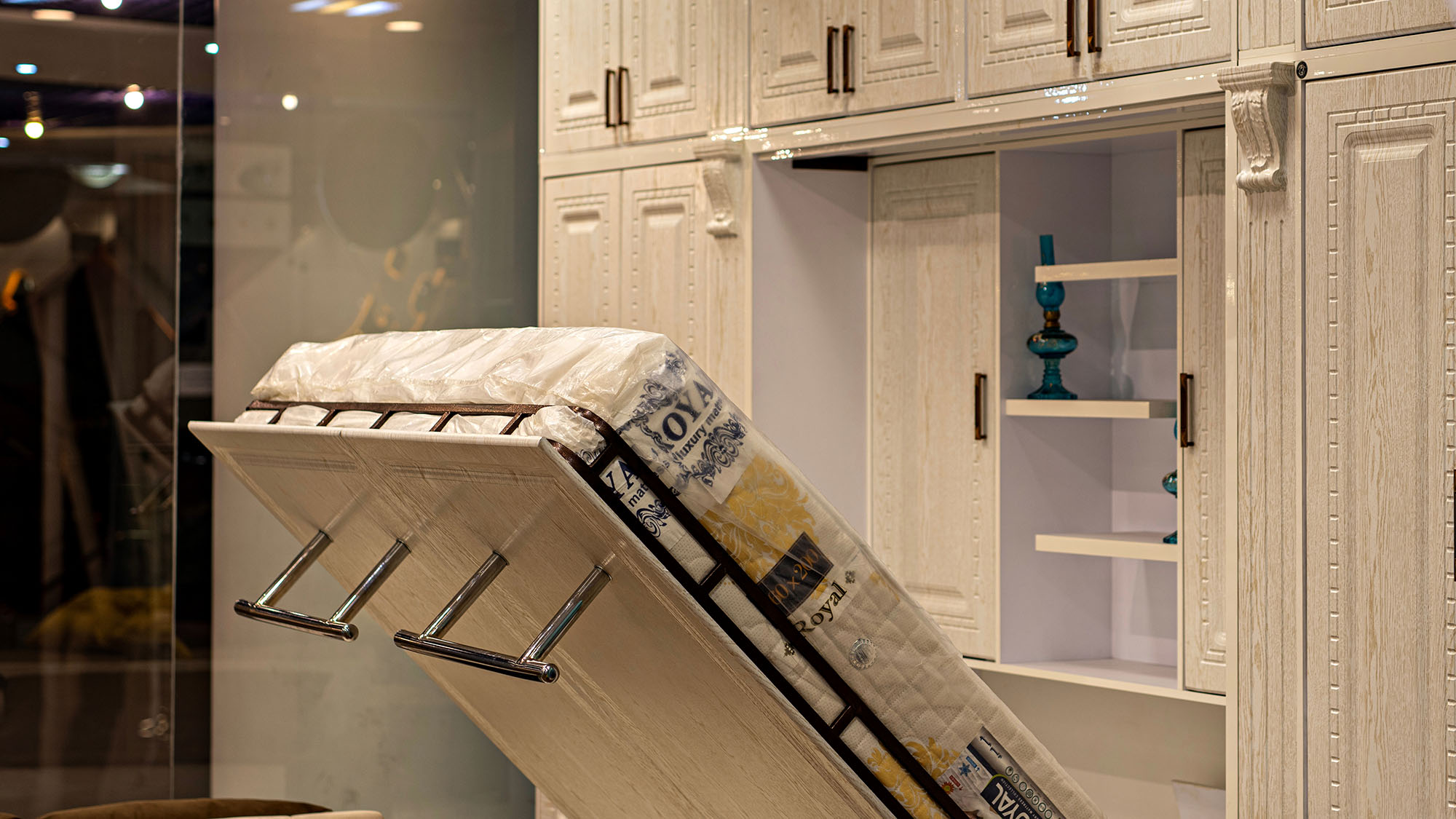 Murphy bed in elegant white storage cabinet in modern bedroom