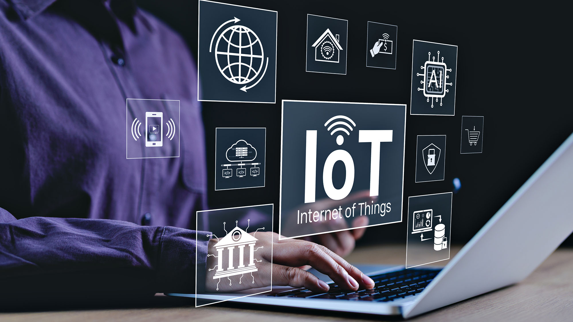 IoT technology icons over laptop in digital workspace