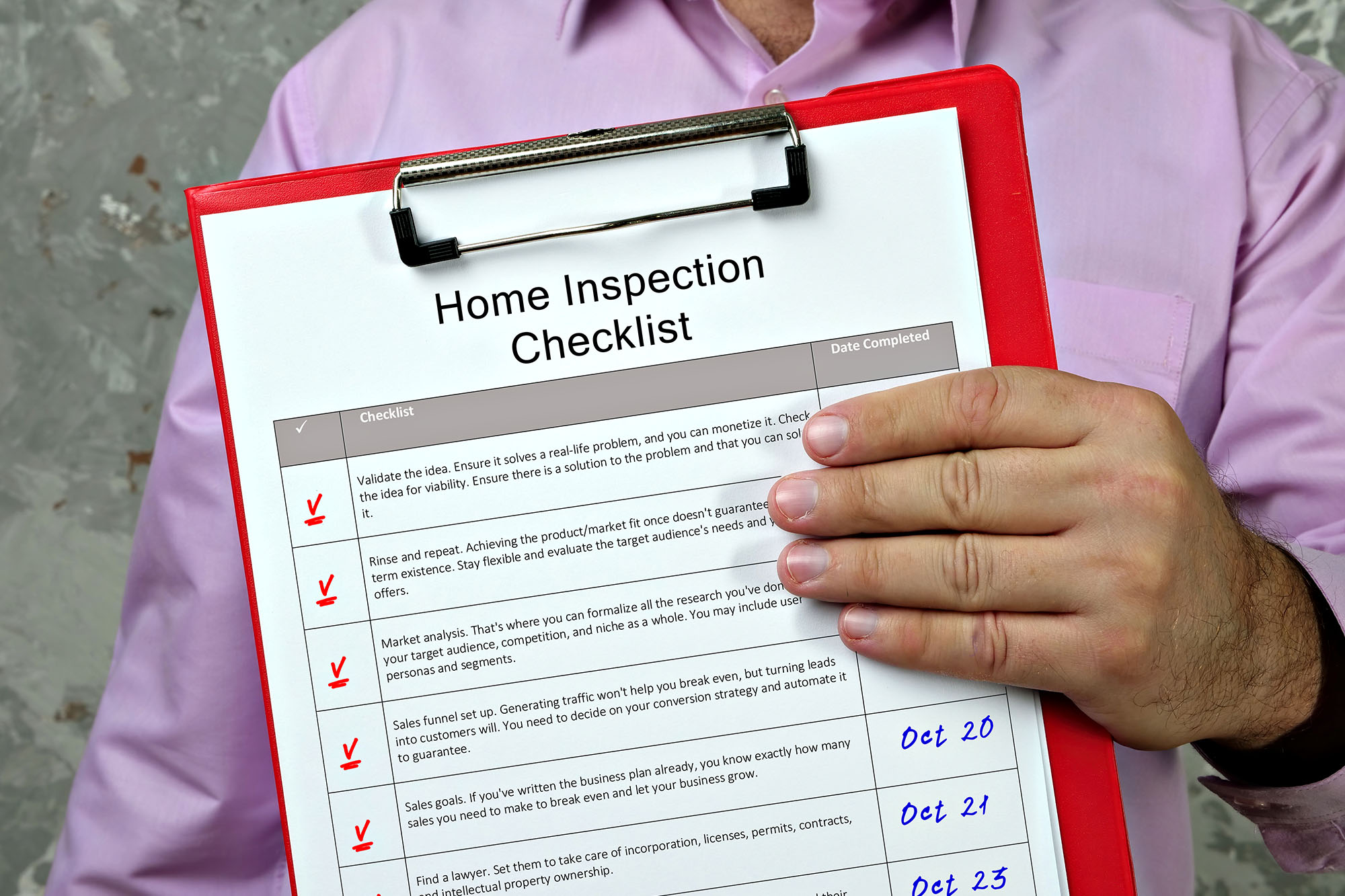 Home inspector holding a red clipboard with a detailed checklist document