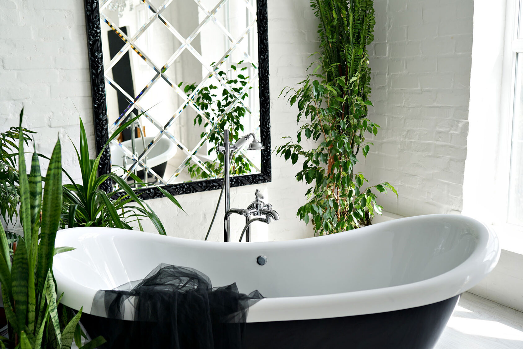 Luxurious bathroom with a freestanding tub and lush greenery