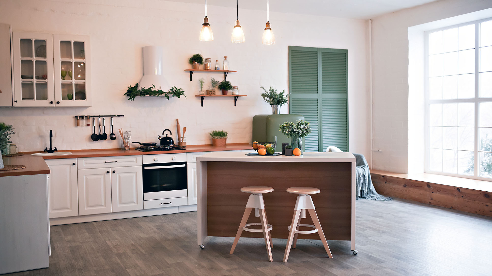 Modern kitchen with centre island, pendant lights, and large window