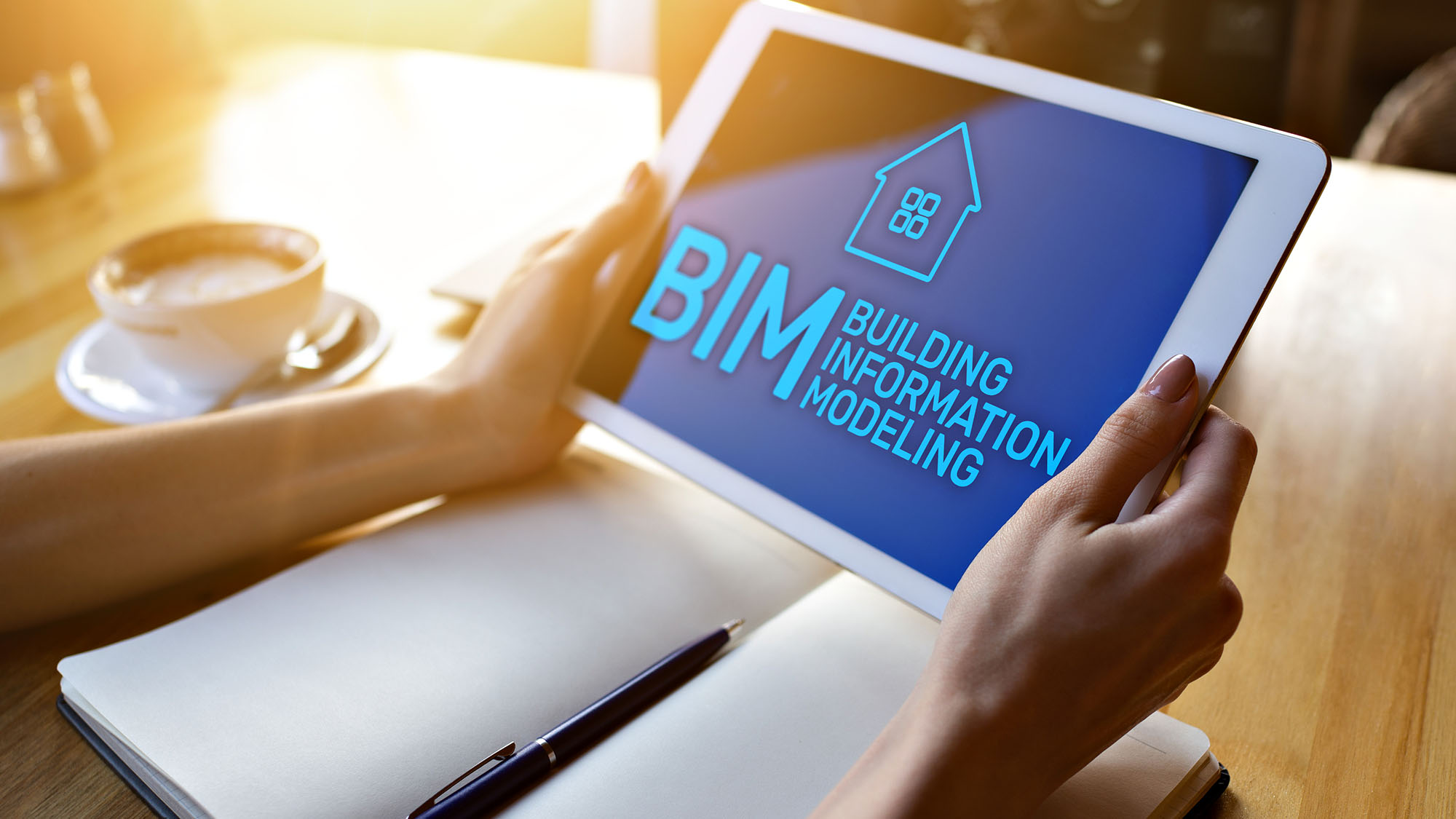 Person using a tablet displaying BIM Building Information Modeling