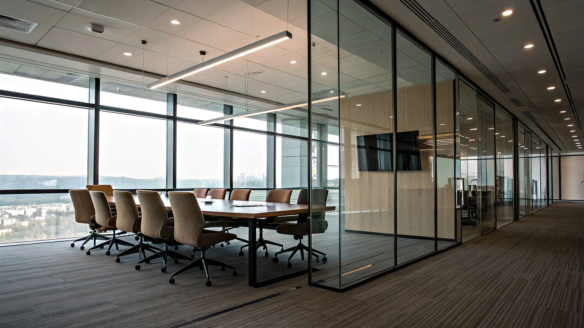 Modern office conference room with glass walls and city view