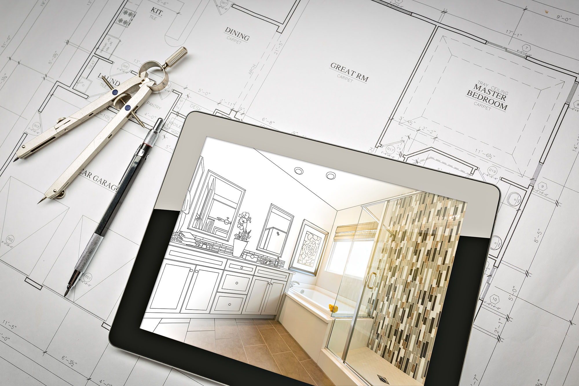 Bathroom design plans on tablet over architectural blueprints