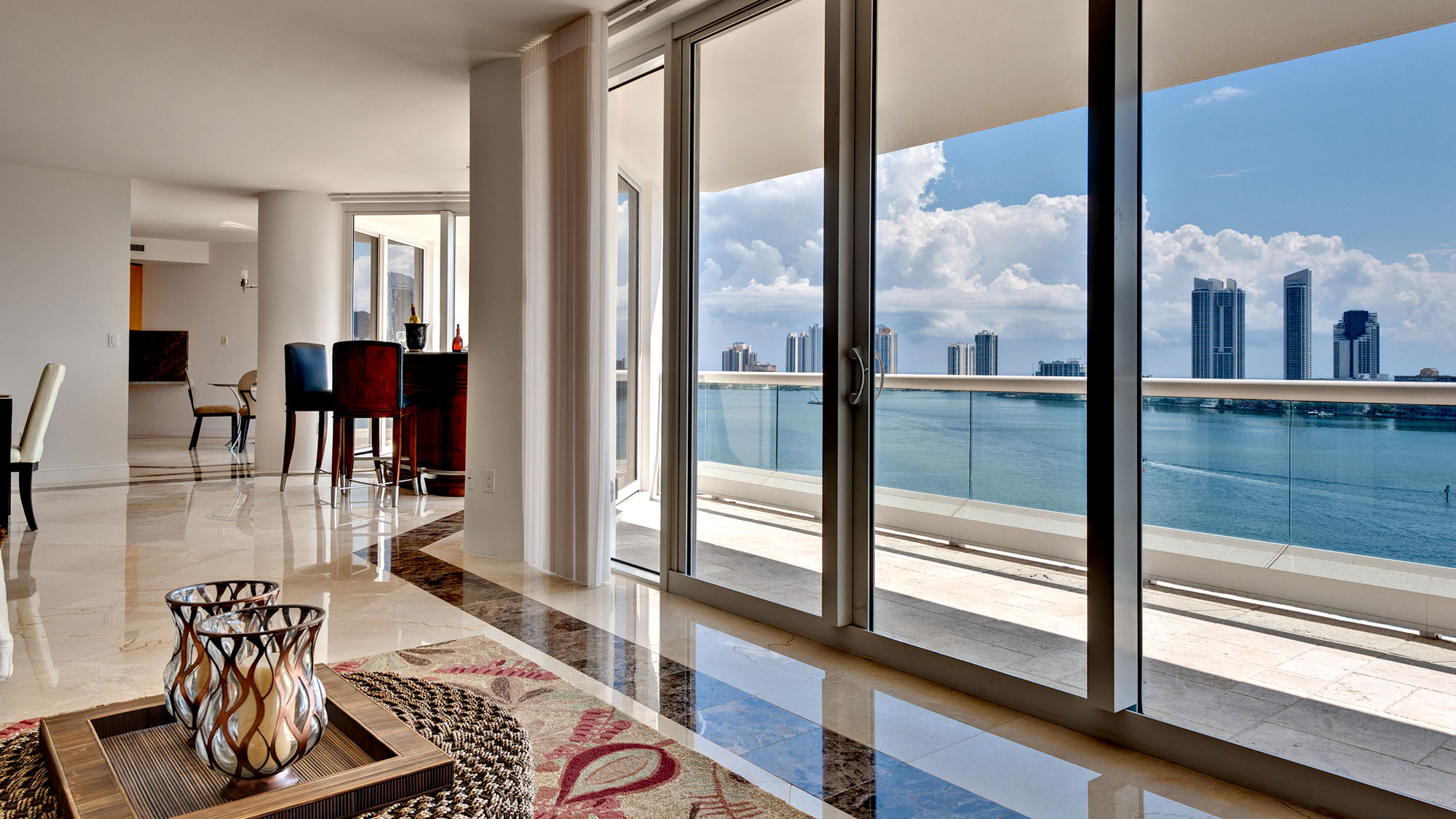 Modern beachfront condo interior with ocean view and large windows
