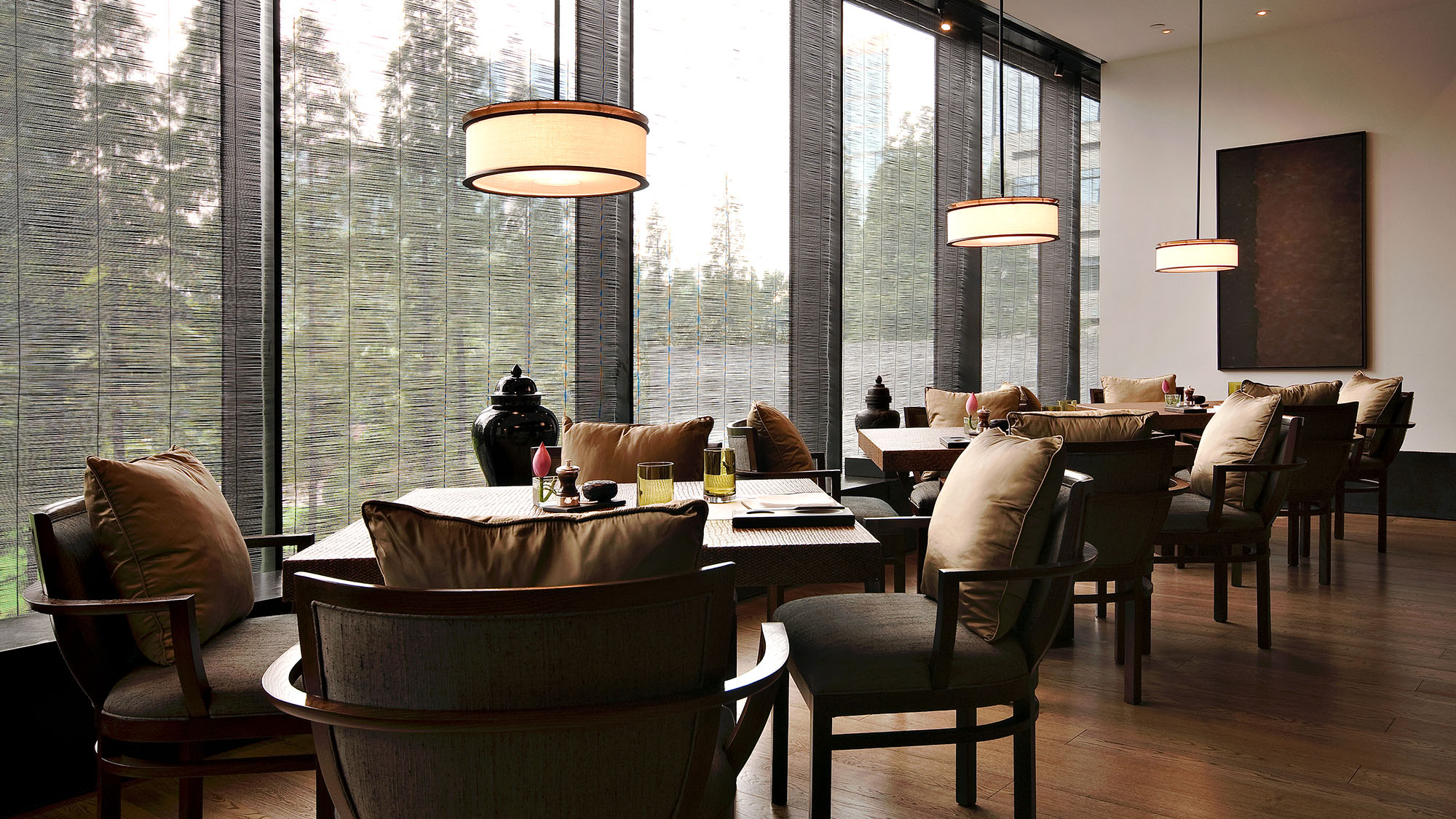 Elegant restaurant interior with natural light and wooden furnishings