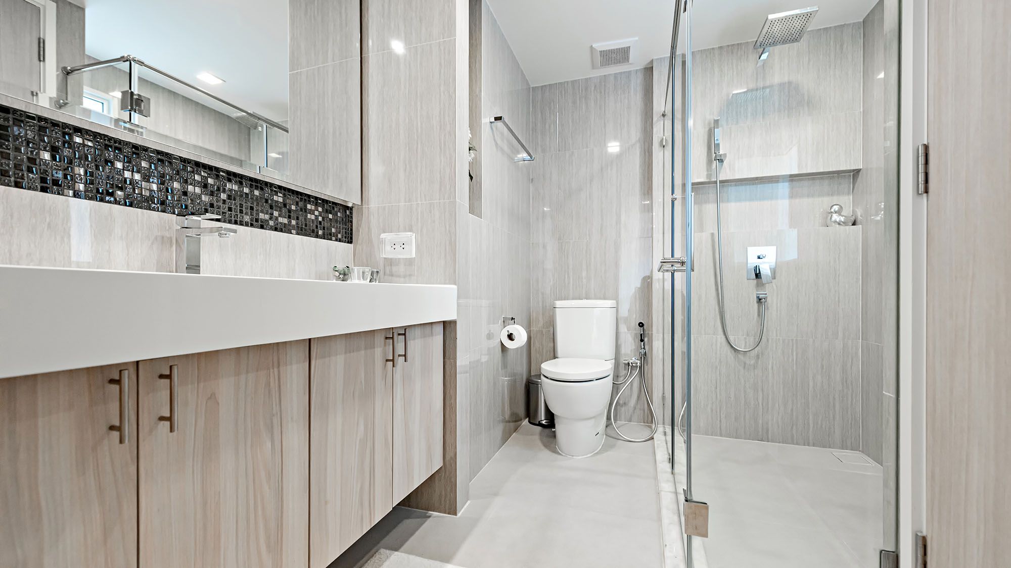 Modern bathroom with glass shower and sleek tiles