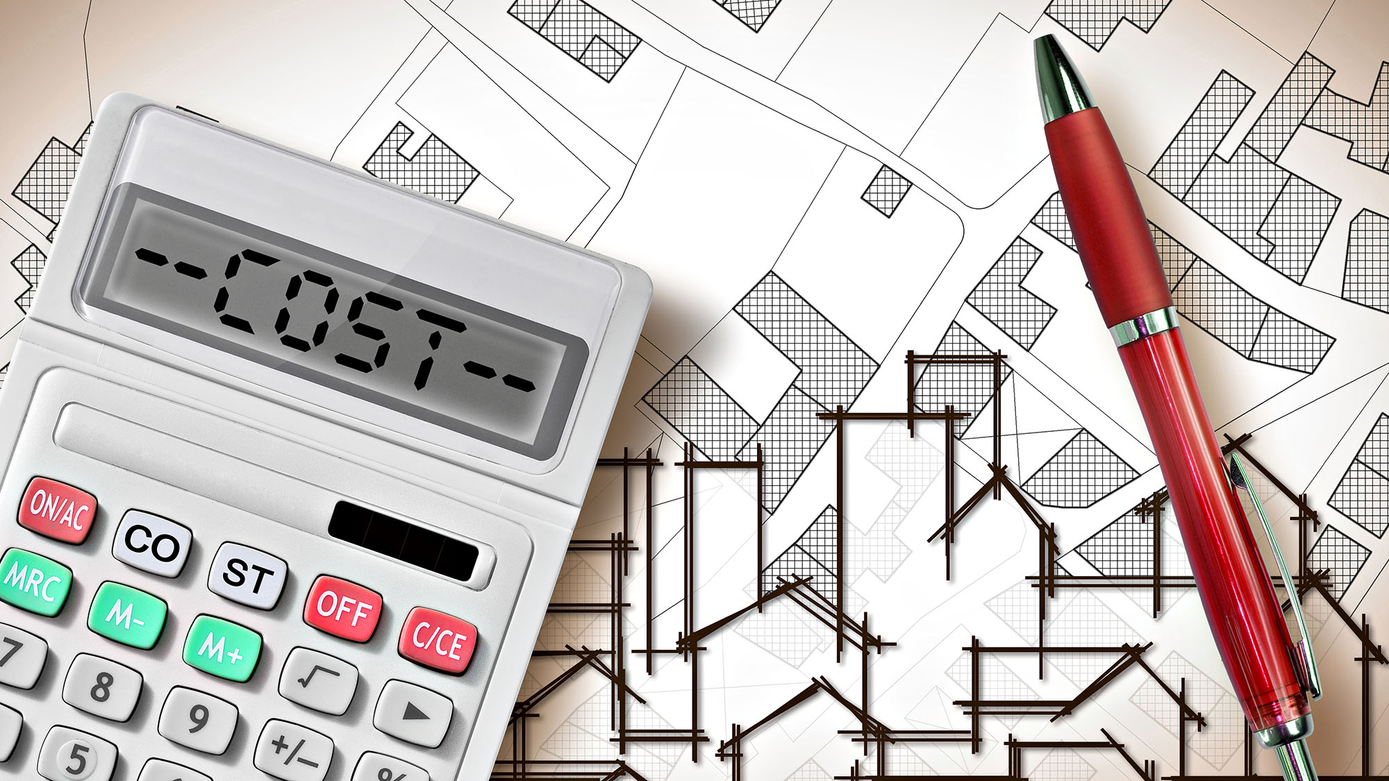 Calculator and pen on architectural plans for construction cost estimation