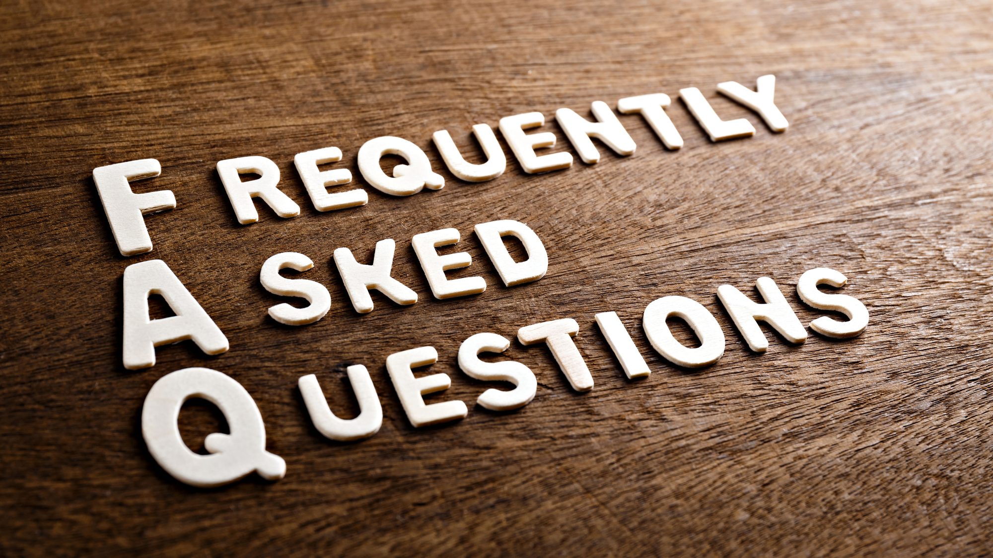 Frequently Asked Questions on wooden background