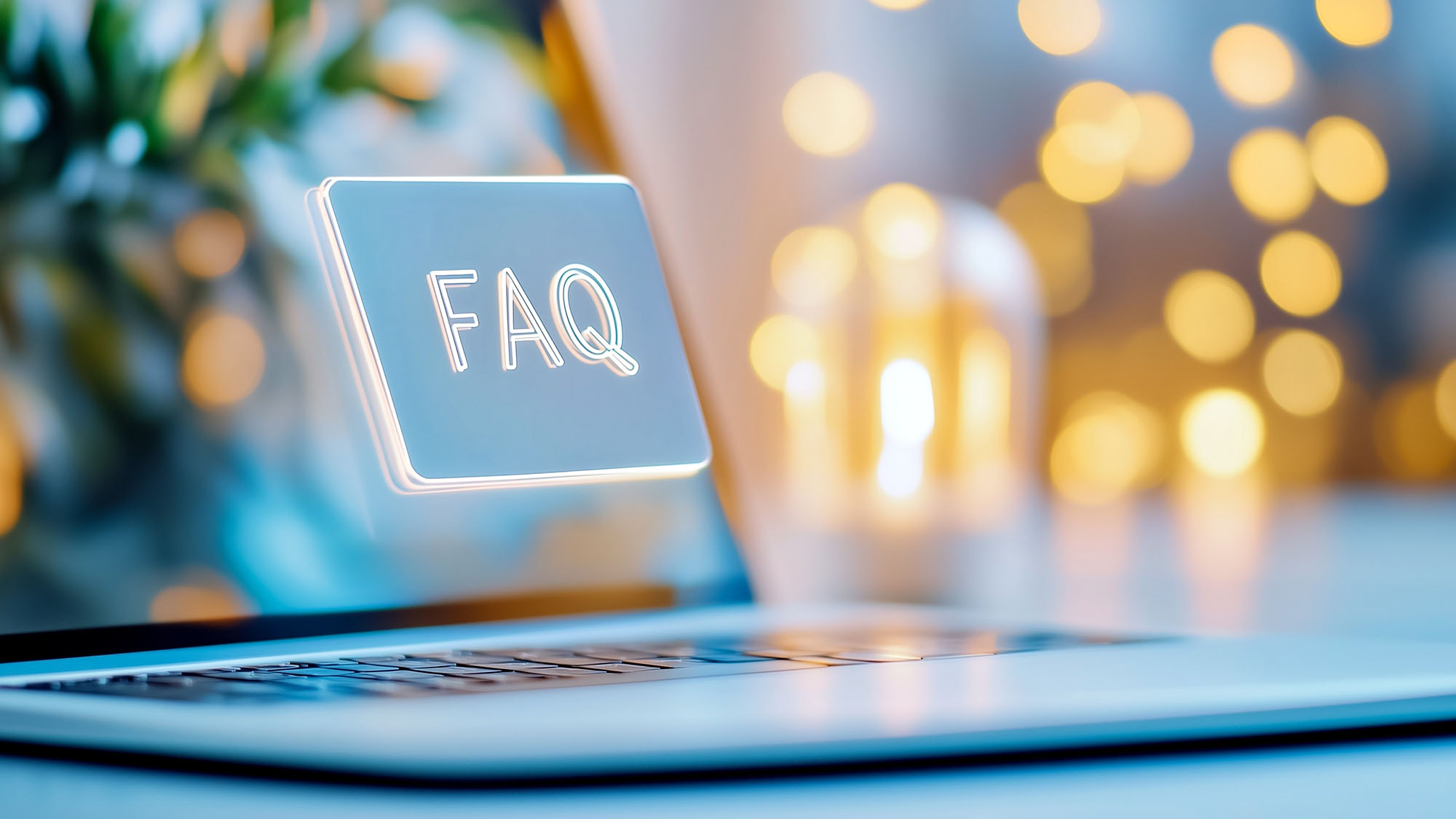Laptop screen displaying FAQ hologram with bokeh lights