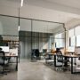 Modern small office interior with white walls and concrete floors, 3d rendering
