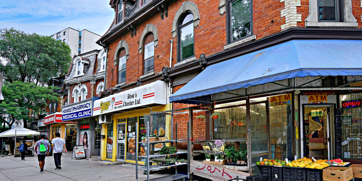 Busy Toronto street with shops and people walking during daytime