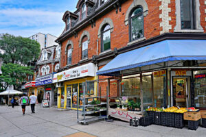 Busy Toronto street with shops and people walking during daytime