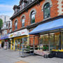 Busy Toronto street with shops and people walking during daytime