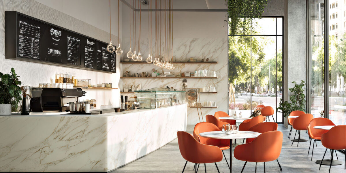 Modern cafe interior with marble counters and orange chairs