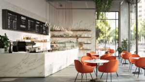 Modern cafe interior with marble counters and orange chairs