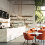 Modern cafe interior with marble counters and orange chairs