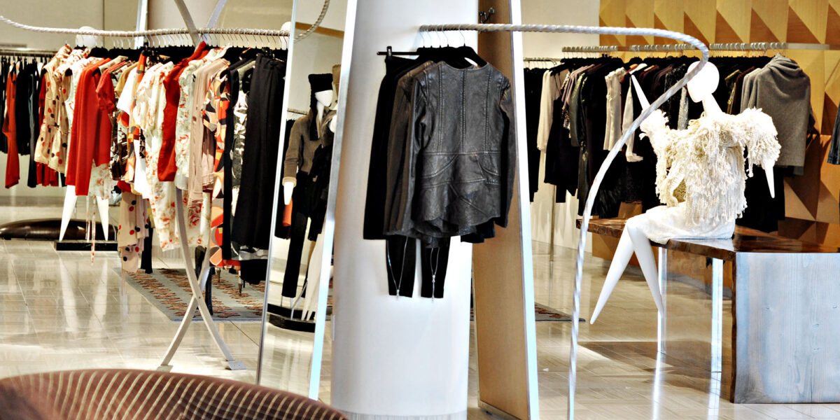 Elegant boutique showcasing luxury designer fashion pieces on racks