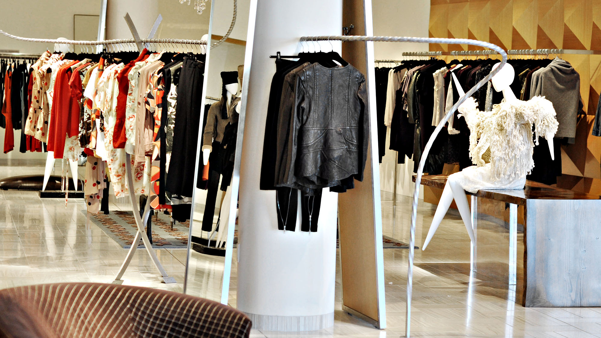 Elegant boutique showcasing luxury designer fashion pieces on racks