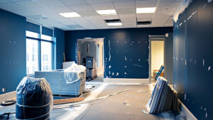 Office under renovation with blue walls and construction materials