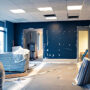 Office under renovation with blue walls and construction materials