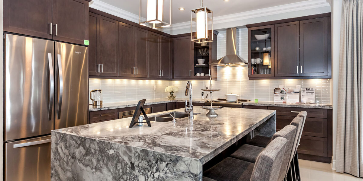 Modern kitchen with marble island and stainless steel appliances