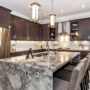 Modern kitchen with marble island and stainless steel appliances
