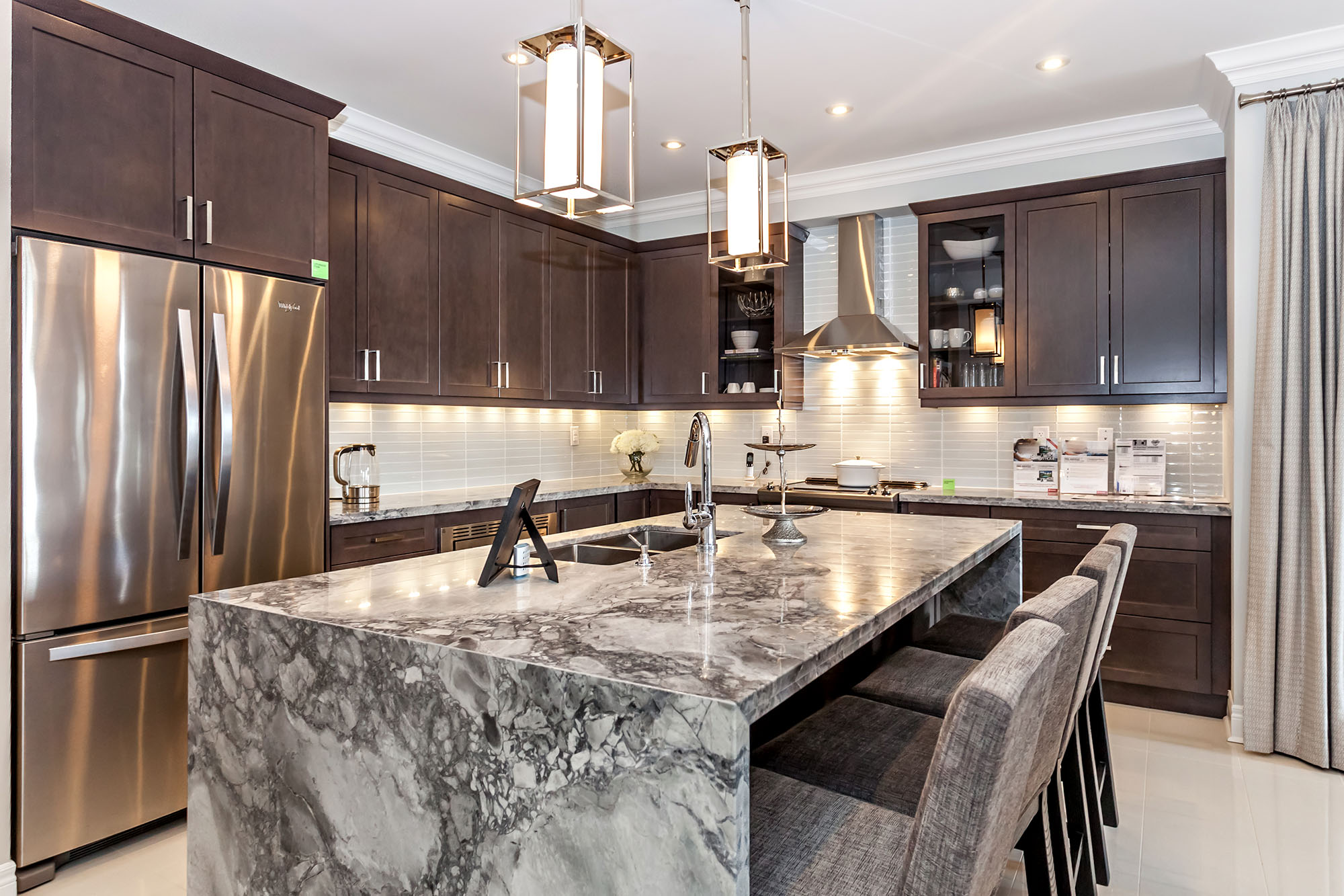 Modern kitchen with marble island and stainless steel appliances