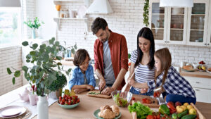 Family cooking together in a bright kitchen with fresh ingredients
