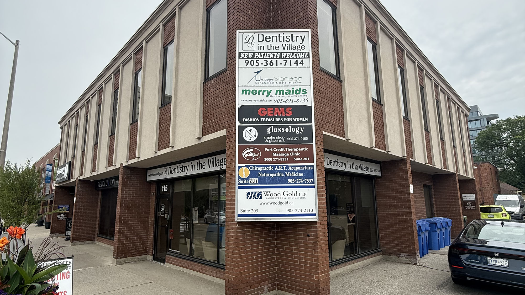Dental office in Clarkson Village Plaza, Mississauga featuring various business signs