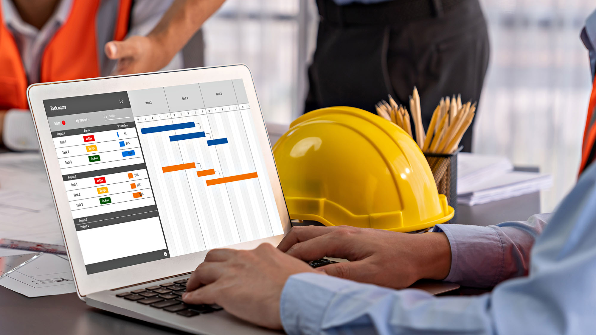 Project management software on laptop in construction office