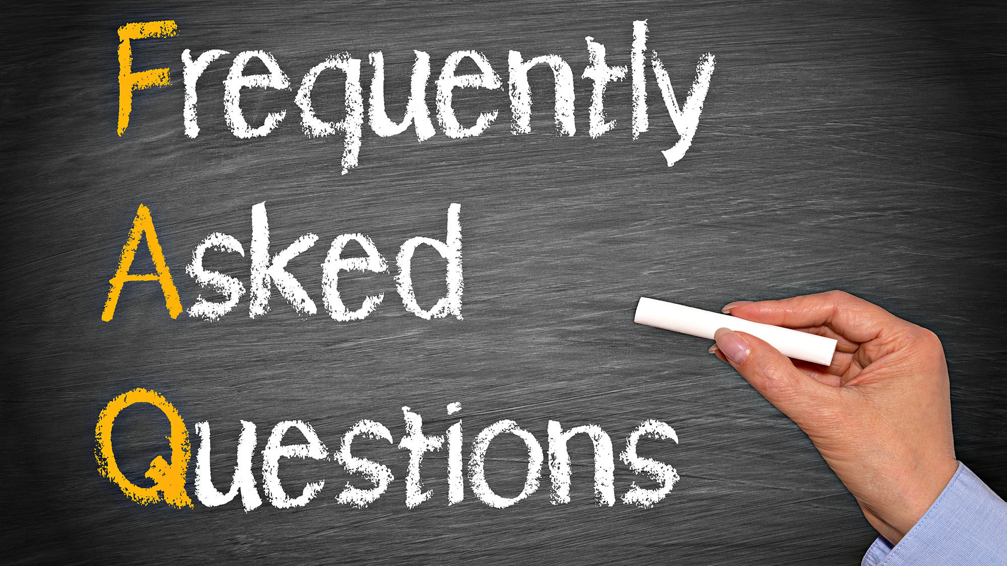 Frequently Asked Questions written on a chalkboard with coloured letters
