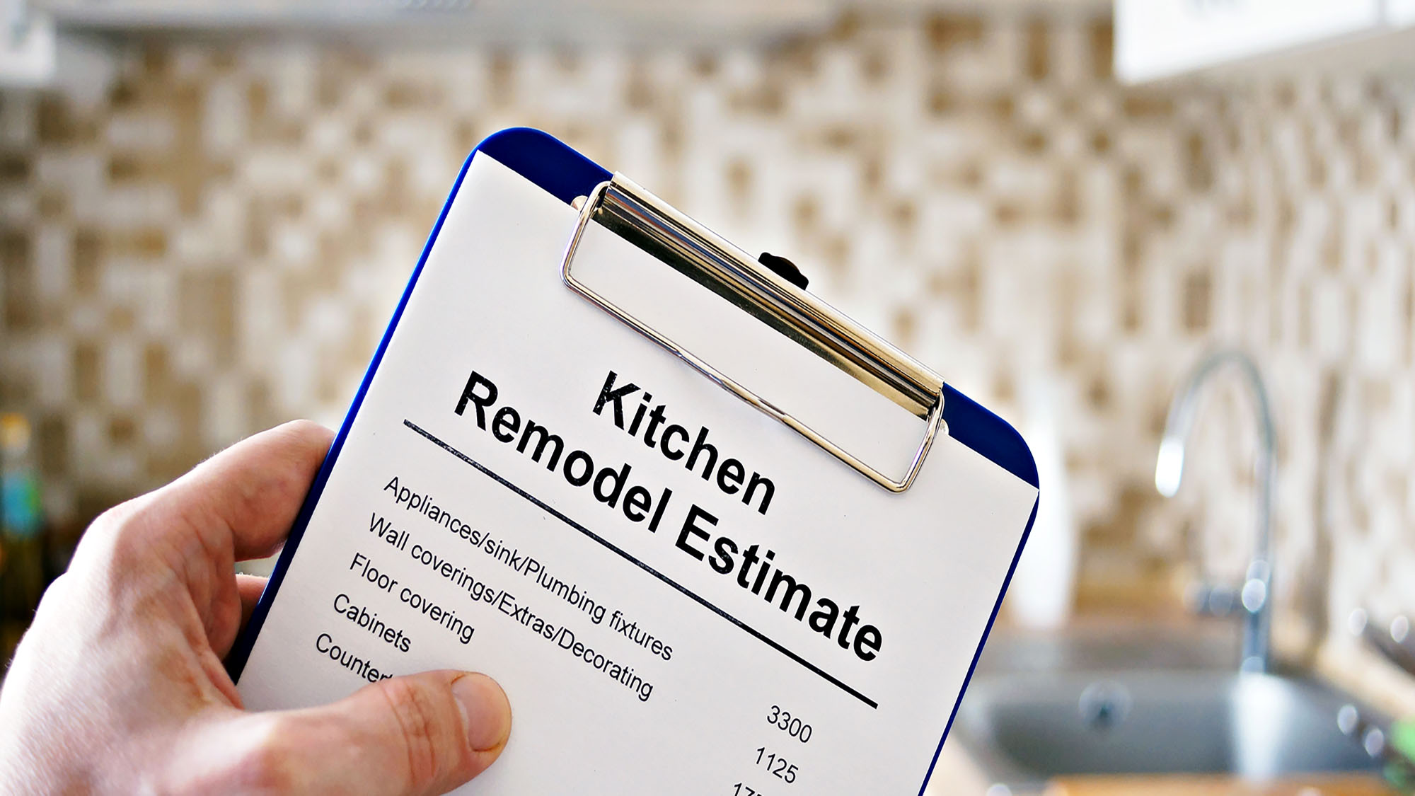 Kitchen remodel estimate displayed on clipboard in renovated kitchen