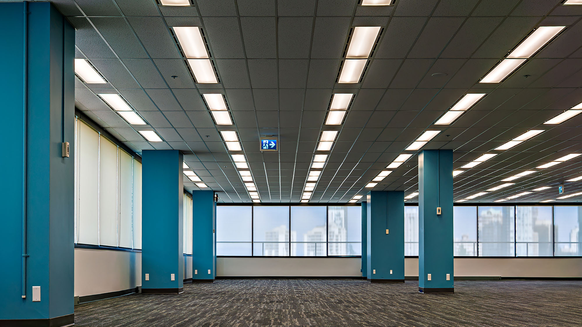 Modern office interior with blue columns and large windows