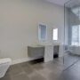 Beautifully appointed bathroom renovation with glass shower, floating shelves, great lighting.