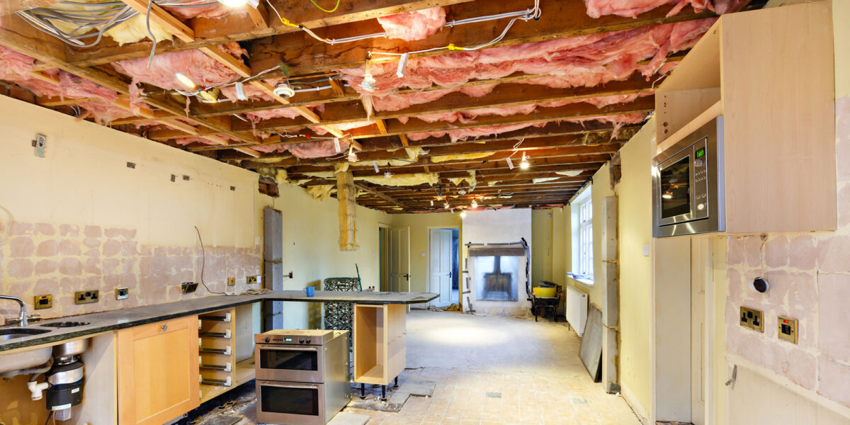 Undergoing kitchen renovation with exposed wiring and insulation