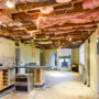 Undergoing kitchen renovation with exposed wiring and insulation