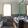 Outdated bathroom with old styee counter and cabinets.