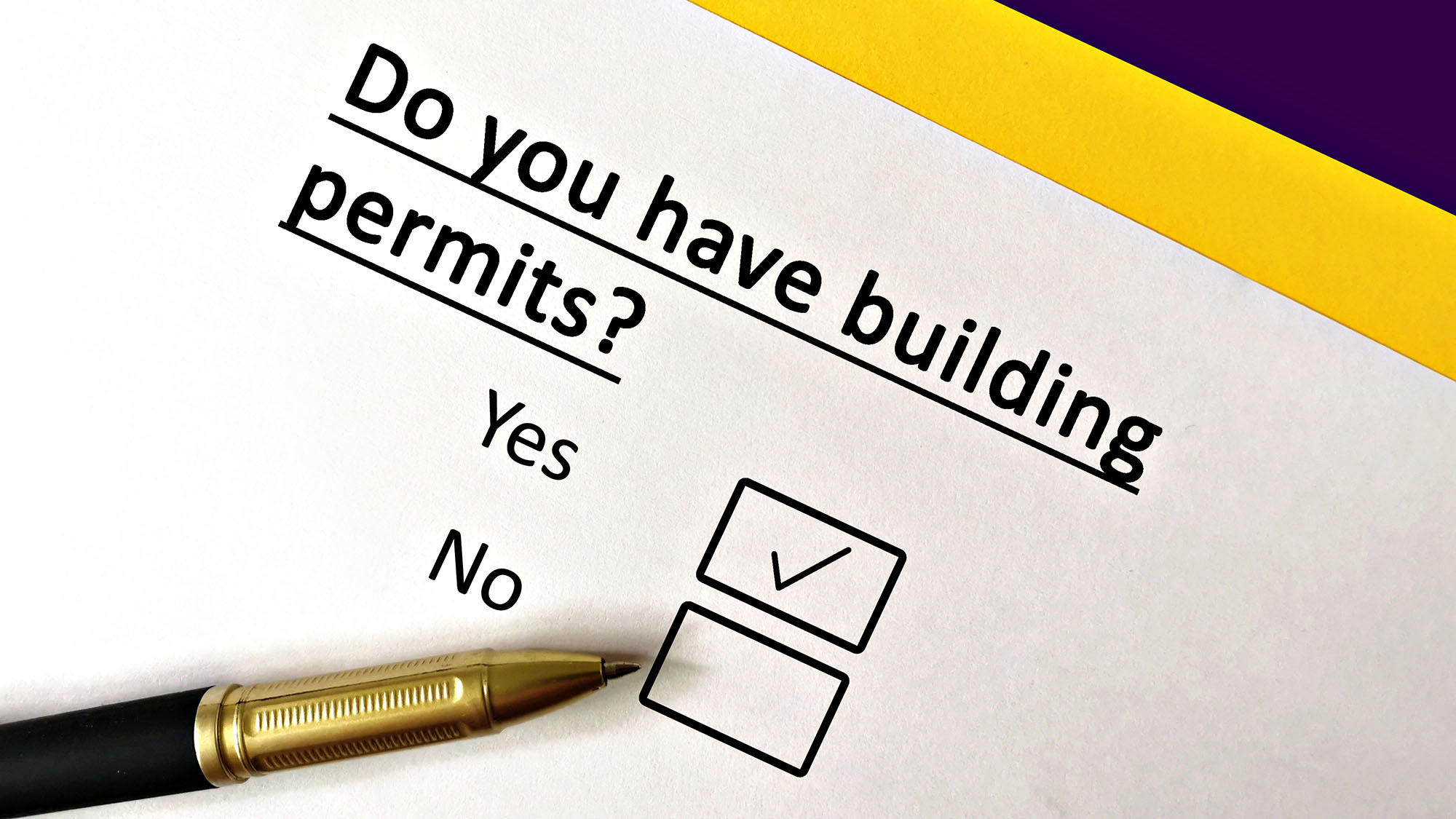 Checklist asking about building permits with a pen on paper